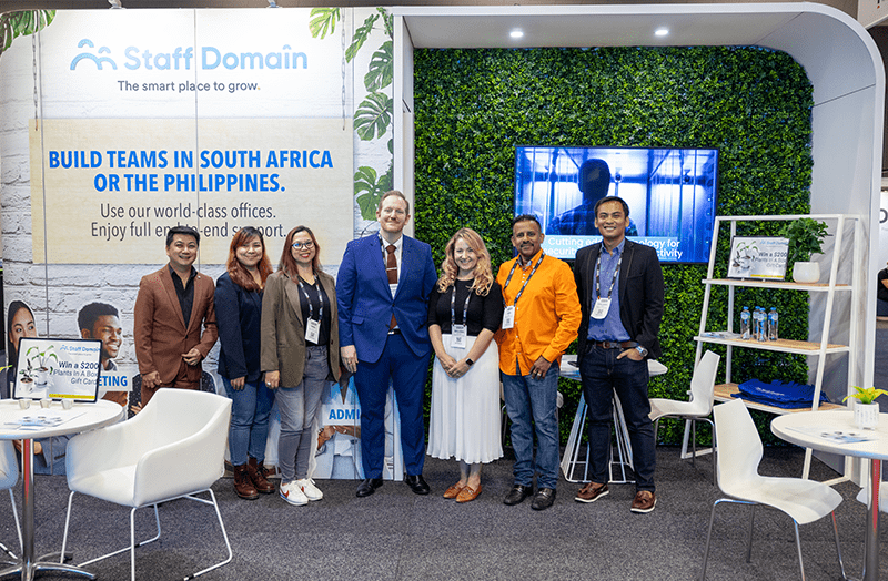 The Staff Domain Team Attends ABE 2023. From Left To Right: Emerson Mendoza, HR Manager. Ronabeth Flores, Recruitment Partner. Nikki Buan, Customer Success Manager. Justin Pavsic, CEO. Melissa Bachmann, Head of Growth. Ben Rajah, CFO. Carlmarc Salting, Business Development Manager