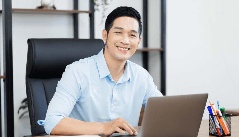 Offshore-AR-officer-at-his-desk-smiling