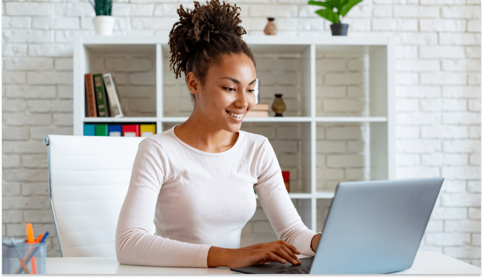 outsource-content-writing-employee-smiling-at-her-laptop