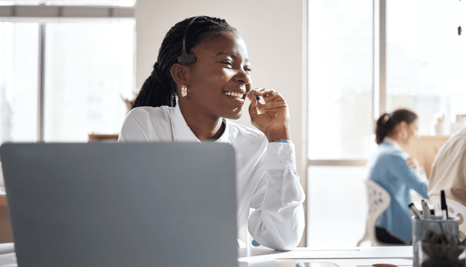 smiling-outsource-administration-employee-talking-over-headset