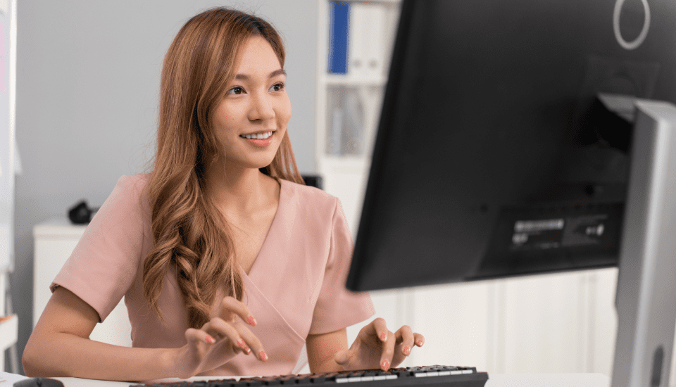 Offshoring-Staffing-Employee-Happily-Working-At-Computer