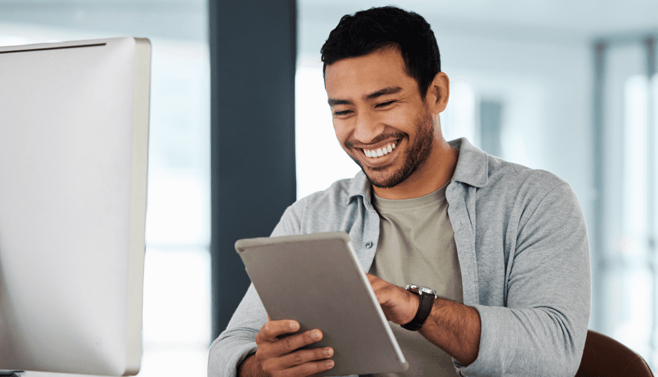smiling-offshore-executive-assistants-employee-using-tablet