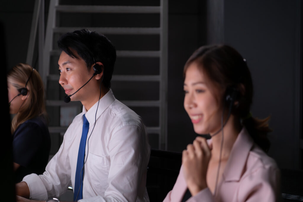 two professionals wearing headphones talking to clients