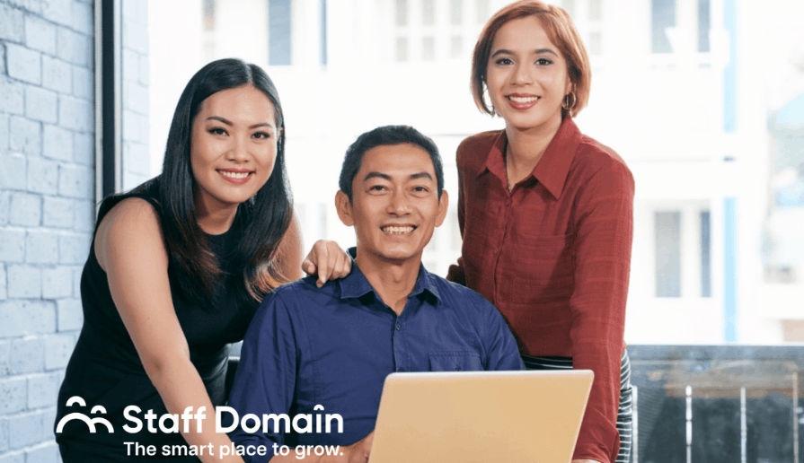 3 Employees smiling for a photograph of global workspace culture