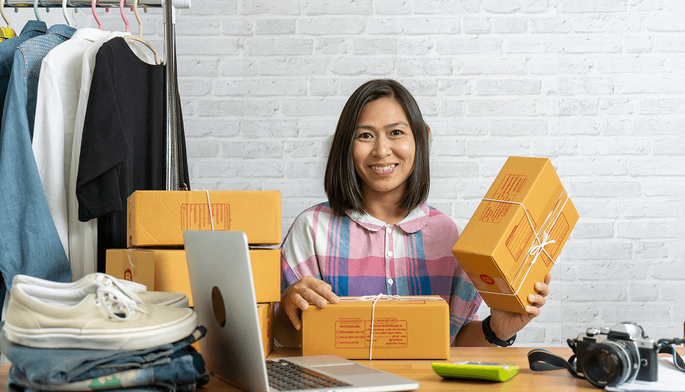 Woman happily managing her products on her headless commerce business