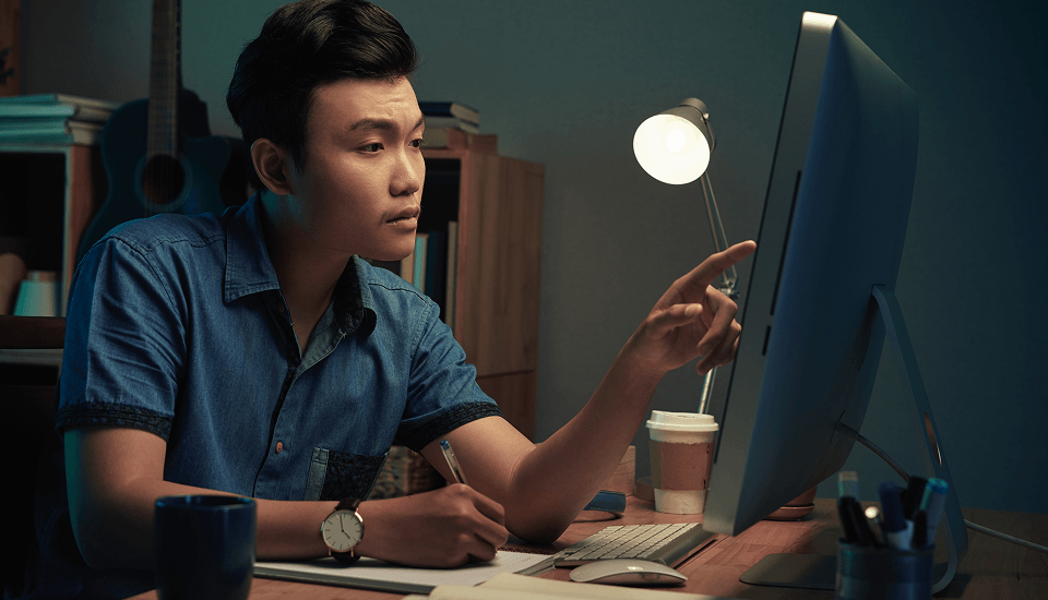 E-commerce website developer pointing at the monitor