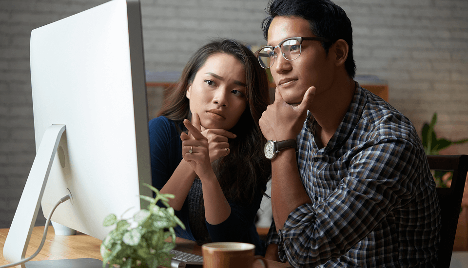 Couple e-commerce website developer thinking about the task