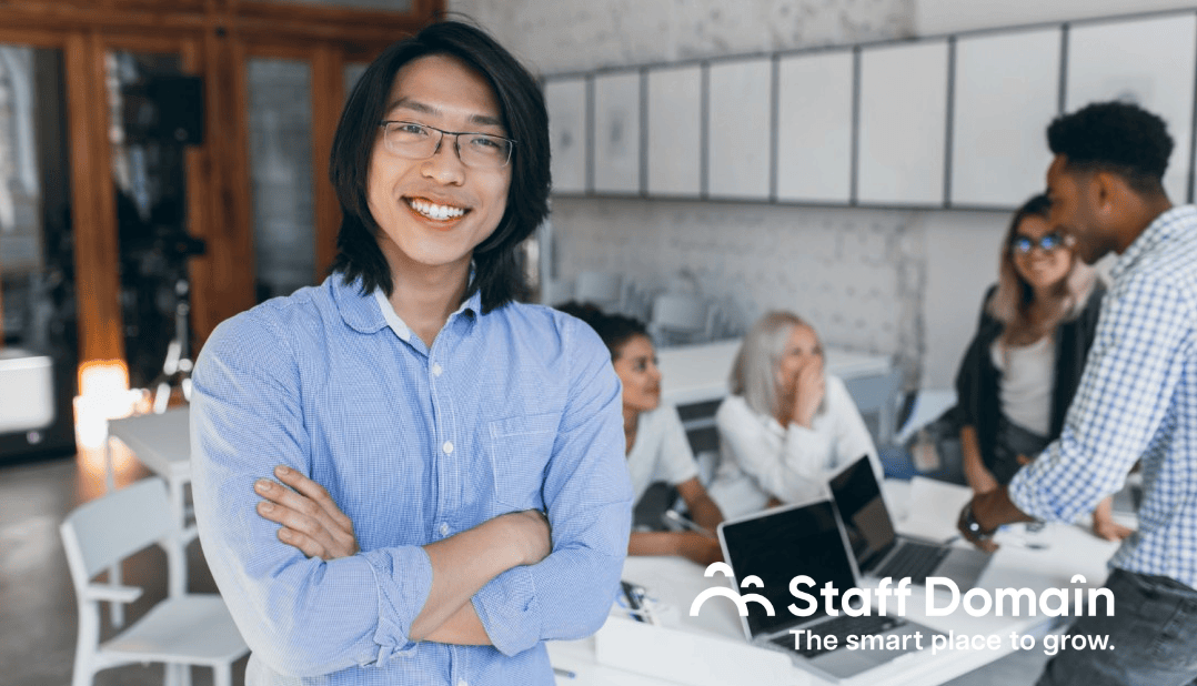 Guy happily posing for a picture because he is proud to know about offshoring for business