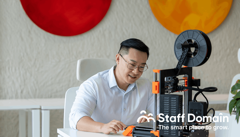A man uses 3d printer to create a model for construction outsourcing