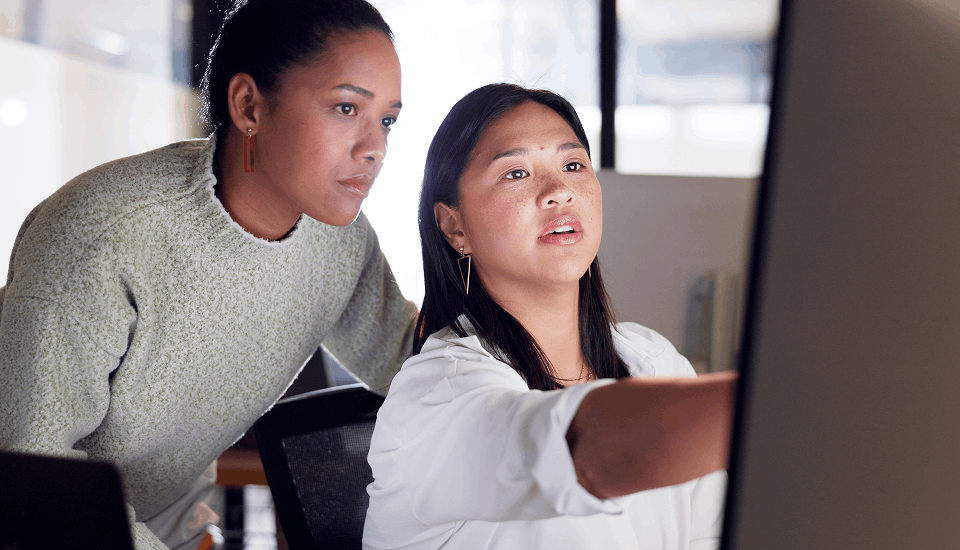 Two person helping each other to craft their CV