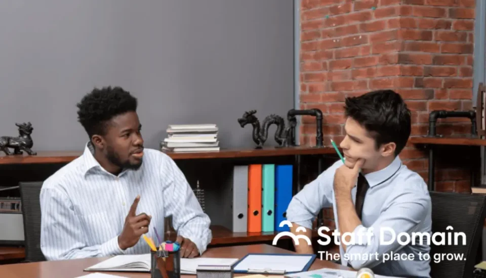 Two employees are talking about outsourcing vs. offshoring