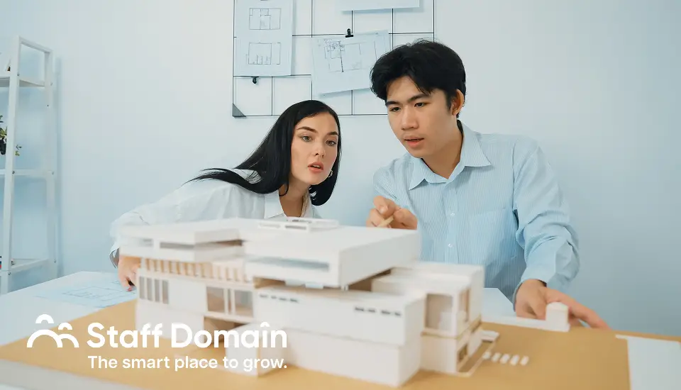 2 people studying how automation in construction will work on their project
