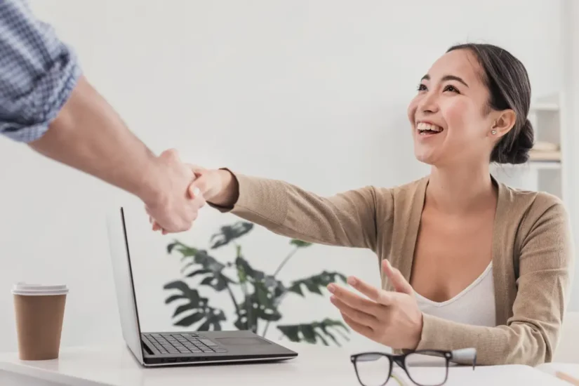 Shaking hands from a business owner and an offshore BPO employee