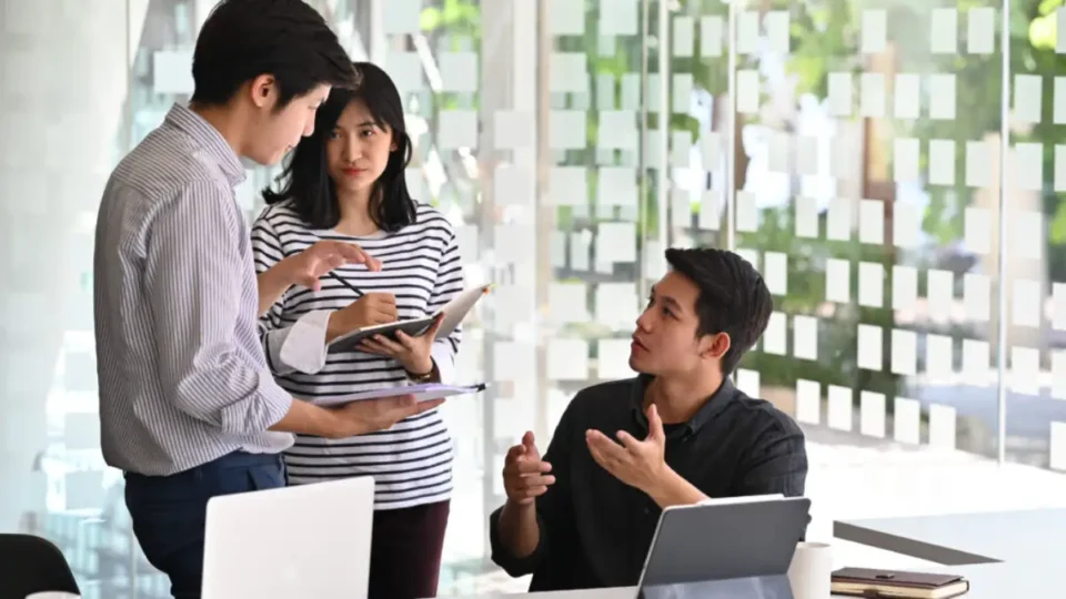 Employees discussing about their roles as an offshore staff